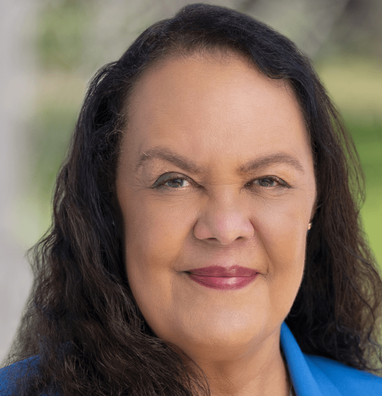 Head shot of woman with blue shirt.